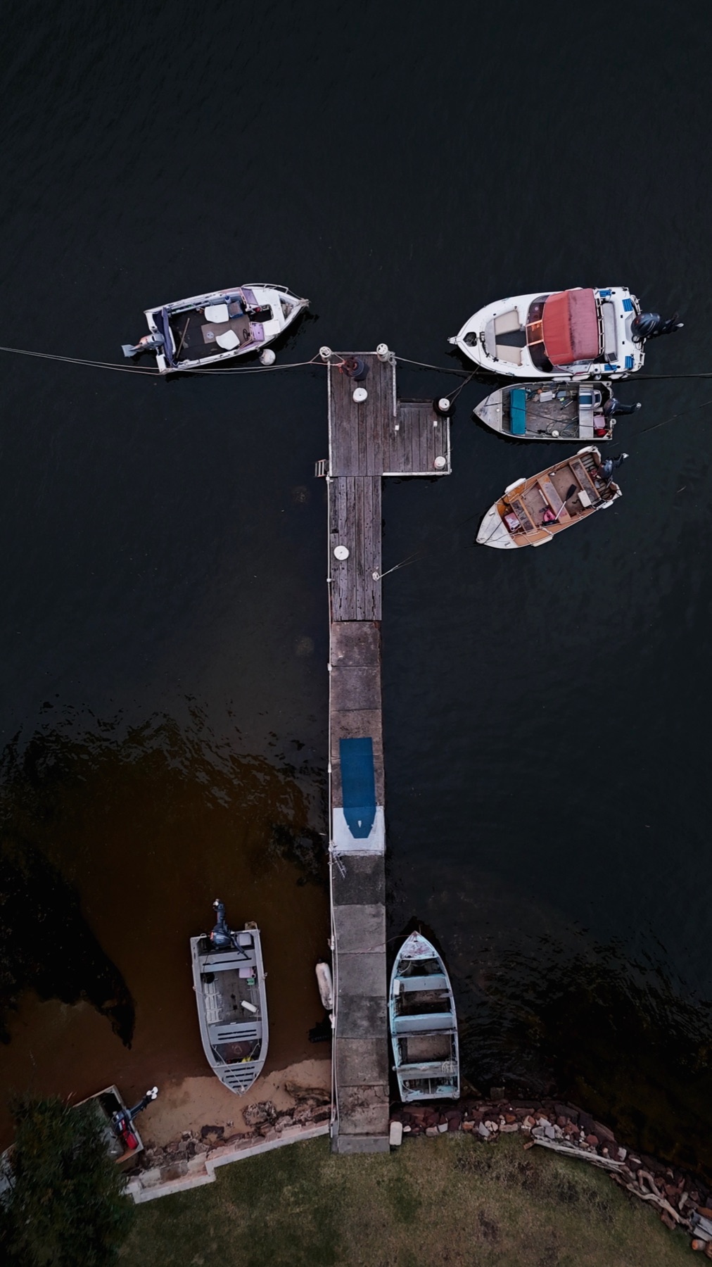 Aerial view of small boats tied to a jetty